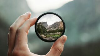 A stunning mountain landscape magnified through a handheld lens highlighting exploration and adventure.