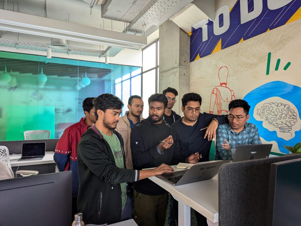 Team of professionals engaged in collaborative work at a vibrant modern office, showcasing teamwork and innovation.