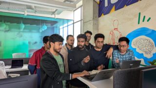 Team of professionals engaged in collaborative work at a vibrant modern office, showcasing teamwork and innovation.
